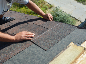 Athens roofer installing architectural shingles on a residential roof.