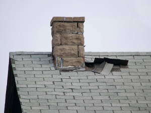 Diligent homeowner in Gun Barrel City inspecting roof for annual upkeep