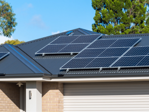 Energy-efficient solar roof panels in a snowy Mabank winter landscape