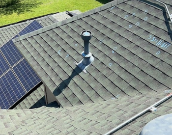 Roofing contractor inspecting roof in Kaufman, TX