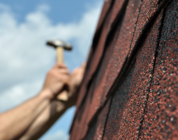 Worn shingles being replaced by a roofing contractor in Corsicana, TX