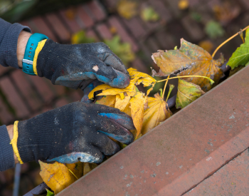 Cleaning gutters on a roof in Corsicana, TX